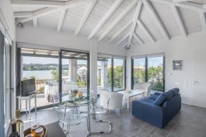 a living room with a blue couch and a table at Minimal Sea View Maisonette in Porto Heli