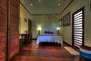 a bedroom with a bed in a room at Hotel Gerard et Francine in Ambatoloaka