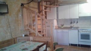 a kitchen with a wooden staircase in a room at Holiday home Désirée in Sorico