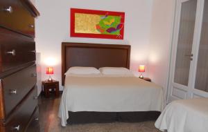 a bedroom with a bed and two lamps on tables at Palazzo De Tomasi B&B in Gallipoli