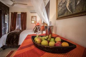 a bowl of fruit on a table in a hotel room at Manzini Cottage in Marloth Park