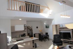 a living room with a kitchen and a dining room at Appartement Mezzanine in Hévíz