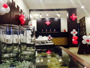 a restaurant with a table with glasses of water and balloons at Hotel The Onix in Dehradun