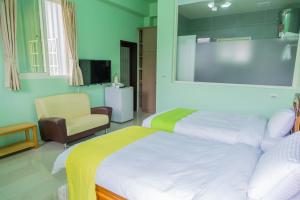 a hotel room with a bed and a chair at Just Stay 稼軒 in Yuanshan