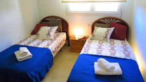 a bedroom with two beds with towels on them at Mia Beach-City apartment in Montgat +44 photos