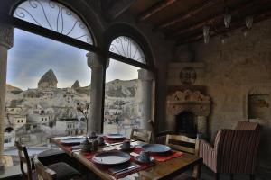 a dining room with a table and a view of a city at Tekkaya Cave Hotel in Goreme