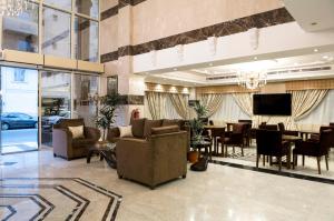a living room with couches and a dining room at Rolana Furnished Apartments in Jeddah