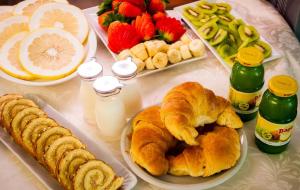 a table topped with croissants and other breakfast foods at Hotel Centrale in Trieste