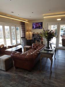 a living room with a couch and a table at Loch Ness Guest House in Fort Augustus