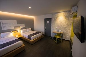 Postel nebo postele na pokoji v ubytování Hotel Perla Central