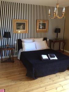 a bedroom with a large bed with two night stands at Le Clos Boutenelle in Éperlecques