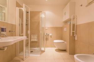 a bathroom with a shower and a toilet and a sink at Wally Residence in Rimini