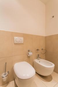 a bathroom with a white toilet and a sink at Wally Residence in Rimini