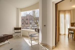 a living room with a view of a balcony at Wally Residence in Rimini