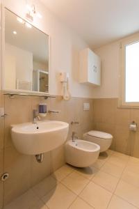 a bathroom with a sink and a toilet at Wally Residence in Rimini