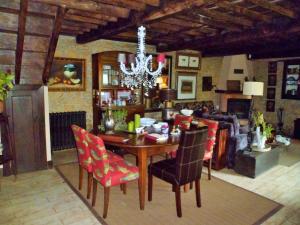 a dining room table with chairs and a chandelier at Casa Rural La Retuerta in Nava