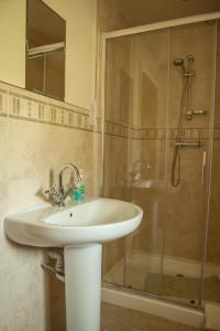 a bathroom with a sink and a shower at Bramble Cottage & Rossmoor Cottage in Stainburn