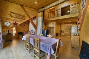 a dining room with a table and chairs in a room at Appartement Le Chalet in Ornans