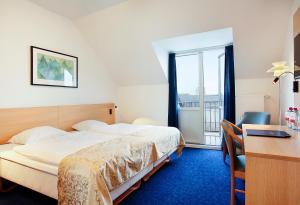 Voodi või voodid majutusasutuse Herning City Hotel toas