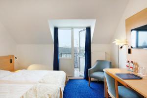 Voodi või voodid majutusasutuse Herning City Hotel toas