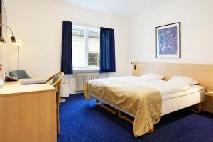 Voodi või voodid majutusasutuse Herning City Hotel toas