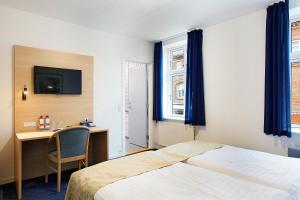 Voodi või voodid majutusasutuse Herning City Hotel toas