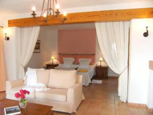 a living room with a couch and a table at Hotel Rural Can Maries in Puerto de San Miguel