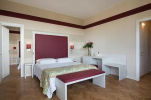 1 dormitorio con cama, escritorio y mesa en Grand Hotel Panoramic, en Montecatini Terme