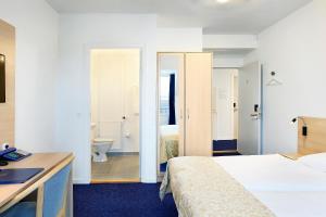 Voodi või voodid majutusasutuse Herning City Hotel toas