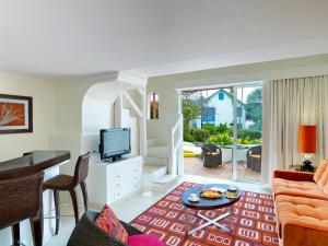 a living room with a couch and a table at Crystal Cove, Barbados, A Tribute Portfolio All-Inclusive Resort in Saint James