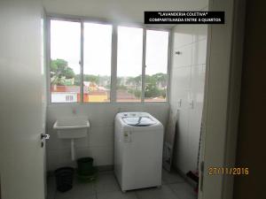 a bathroom with a small refrigerator and a window at Villa Tata Suítes Ltda in Curitiba +59 photos