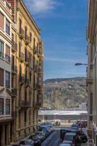 a city street with cars parked next to buildings at Apartamento Urgul in Donostia-San Sebastián