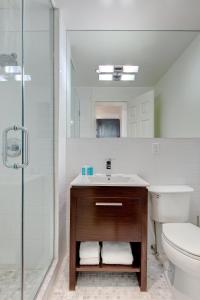 a bathroom with a sink and a toilet and a shower at East Village Hotel in New York