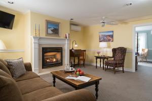 a living room with a couch and a fireplace at Wolf Cove Inn in Poland Spring