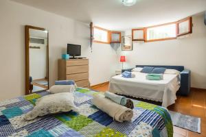 Posteľ alebo postele v izbe v ubytovaní Alghero Guest House - Appartamenti in Villetta di Campagna, Piscina fuori terra a 4 minuti di auto dalla città + 37 fotografií