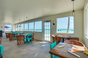 a restaurant with tables and chairs and the ocean at X'tan Ha- The Waterfront in San Pedro