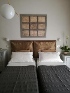A bed or beds in a room at Balneum Boutique Hotel & B&B