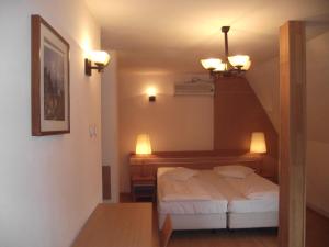 a small room with a bed and a staircase at Villa Carmelita in Craiova