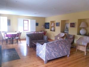 a living room with couches and chairs and a table at Hotel Las Grandas in Vistalegre