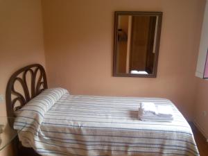 
a bed sitting in a bedroom next to a window at Hotel Las Grandas in Vistalegre
