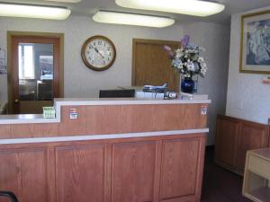 a reception desk with a clock on the wall at Crown Inn in Seattle