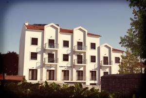 a large white building with balconies on it at Santa Noite in Fátima