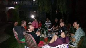 un grupo de personas sentadas en una mesa por la noche en Hotel Mandala, en Pokhara