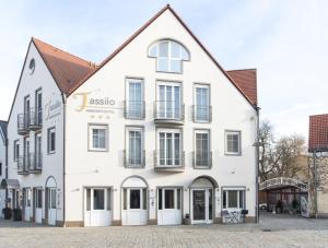 a white building with white doors and windows at Ambienthotel Tassilo in Dingolfing