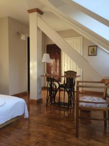 a bedroom with a bed and a table and chairs at Adalbert Ház in Budapest