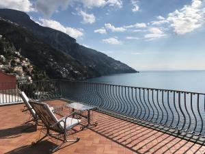 a balcony with a view of the water and mountains at Suite Antimo - Casa Scibetta in Positano