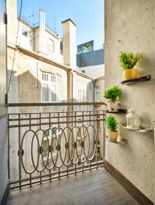 a balcony with potted plants and shelves on the wall at Studio Apartment Green Wall in Zagreb