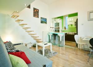 a living room with a staircase and a kitchen at Studio Apartment Green Wall in Zagreb
