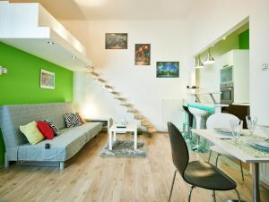 a living room with a couch and a table at Studio Apartment Green Wall in Zagreb