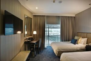 Uma cama ou camas num quarto em Ambassador Transit Hotel - Terminal 3